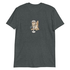 May include: A dark heather grey t-shirt with a graphic of a cat peeking out of a champagne glass.