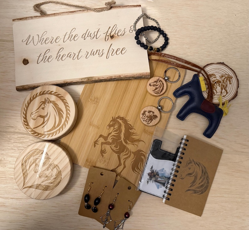 May include: A collection of horse-themed items, including a wooden sign with text, coasters, keychains, a cutting board, a leather horse figurine, earrings, a bracelet, and a notebook. The items are in shades of brown, black, and blue.