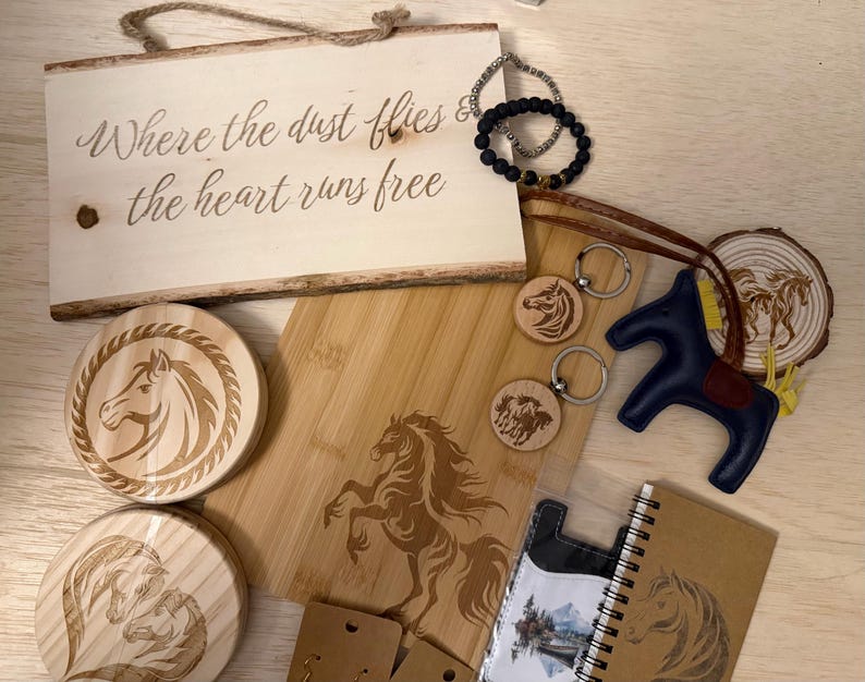 May include: A collection of horse-themed items, including a wooden sign with text, coasters, keychains, a cutting board, a leather horse figurine, a notebook, and bracelets. The items are in shades of brown, beige, and blue.