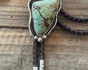Kingman turquoise bolo tie. Handmade. Sterling and fine silver. Braided leather cords. Handmade sterling silver tips.