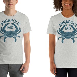 May include: Gray t-shirt with a blue crab and the text "ANNAPOLIS MD" printed on the front.