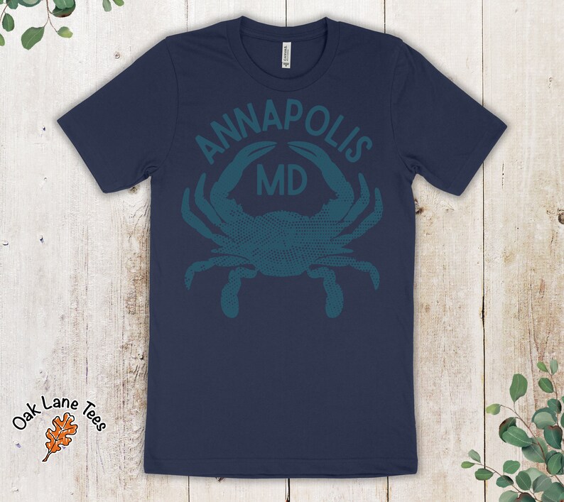 May include: Navy blue t-shirt with a teal blue crab graphic and the text "ANNAPOLIS MD".