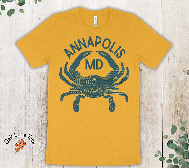 May include: A yellow t-shirt with a blue crab graphic and the text "Annapolis MD".