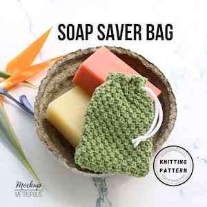 May include: A green knitted soap saver bag with a white drawstring, sitting in a wooden bowl with two bars of soap, one orange and one white. The text "SOAP SAVER BAG" is at the top of the image. The text "KNITTING PATTERN" is in a circle with a white background and black text.
