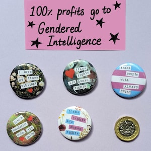 May include: Five colourful button badges with messages about transgender rights. The badges are on a pink surface with a white card that says "100% profits go to * Gendered * Intelligence *"
