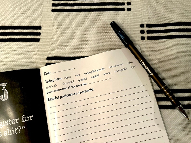 Black and white square page-a-day postpartum journal for new moms.