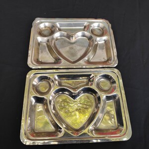 May include: Two silver metal serving trays with five compartments. Each tray has a heart-shaped compartment in the centre.