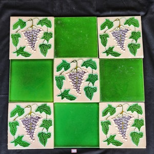 May include: Nine square ceramic tiles with a green background and white vines with purple grapes. The tiles are arranged in a 3x3 grid.