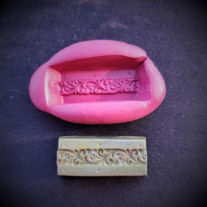 May include: A pink silicone mould with a detailed floral design, and a metal stamp with the same design.