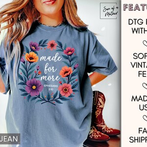 K&ouml;nnte beinhalten: Ein T-Shirt aus Jeansblau mit einem Blumendesign und dem Text "made for more Ephesians 2:10".