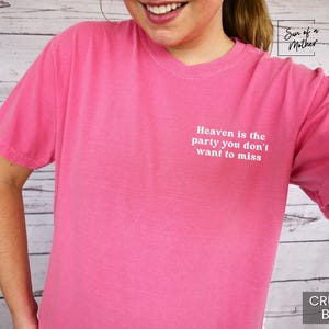 May include: Pink t-shirt with the text "Heaven is the party you don't want to miss" printed on the front. The shirt is made of a soft, comfortable material.