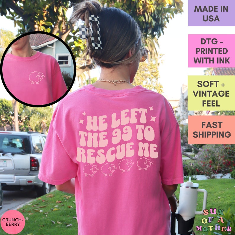 May include: Pink t-shirt with a white graphic that says "He left the 99 to rescue me" with a row of five white sheep below the text. The shirt has a white sheep graphic on the front.