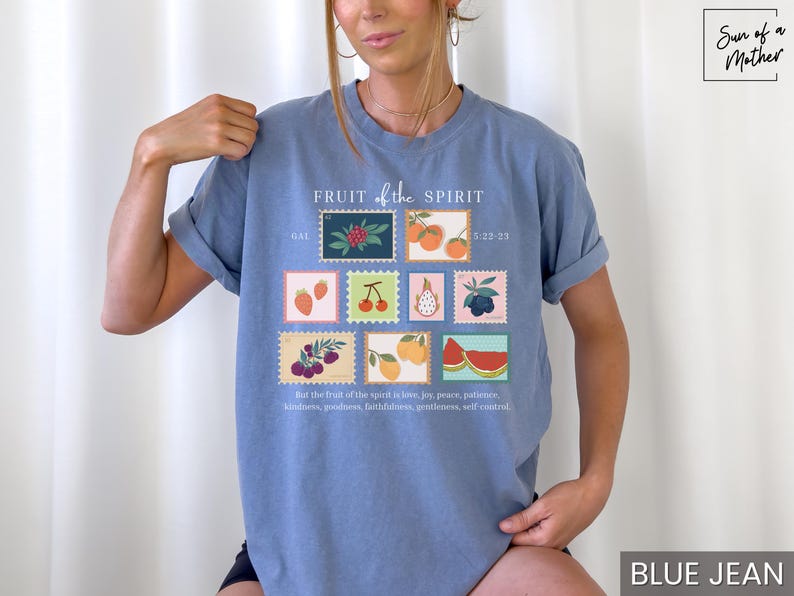 May include: A light blue t-shirt with a graphic of fruit and the text "FRUIT of the SPIRIT" and "GAL 5:22-23". The text "But the fruit of the Spirit is love, joy, peace, patience, kindness, goodness, faithfulness, gentleness, self-control" is printed below the graphic.