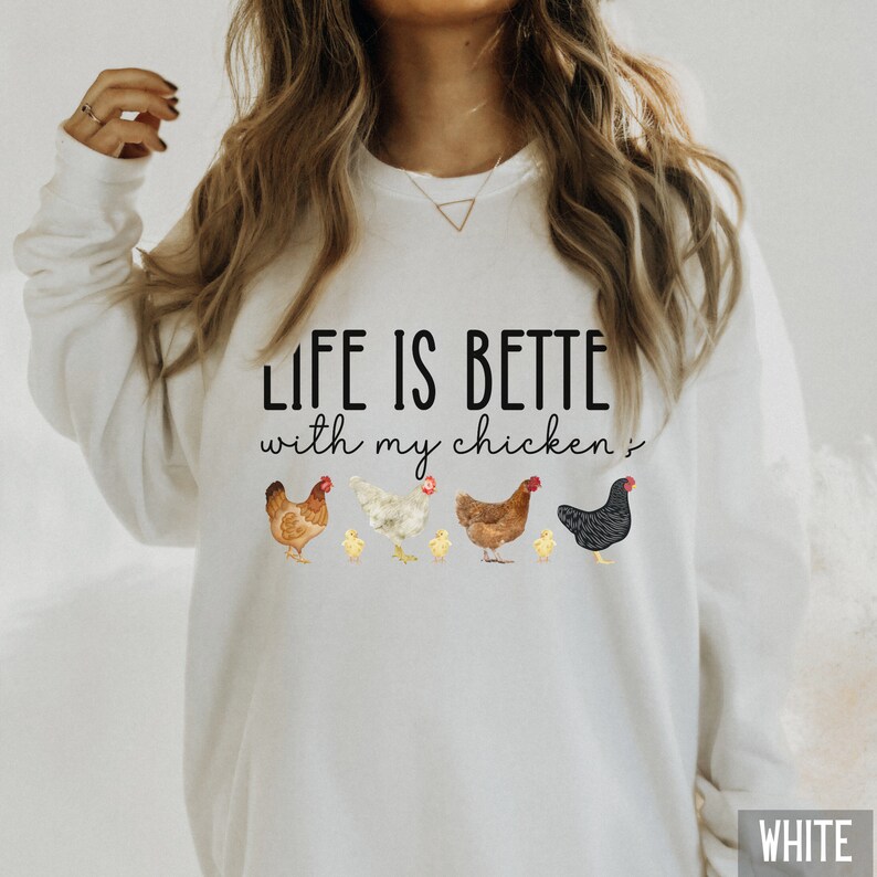 May include: White sweatshirt with the text "Life is better with my chickens" and a line of chickens and chicks printed on the front.