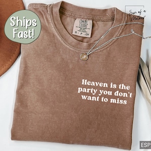May include: A brown t-shirt with the text "Heaven is the party you don't want to miss" printed in white. The shirt is made of a soft, comfortable material.