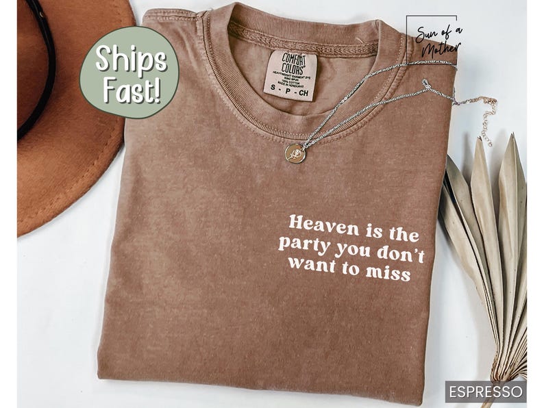 May include: A brown t-shirt with the text "Heaven is the party you don't want to miss" printed in white. The shirt is made of a soft, comfortable material.