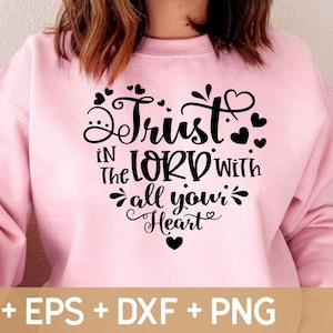 May include: Pink sweatshirt with black text that reads "Trust in the Lord with all your Heart" with small hearts surrounding the text.