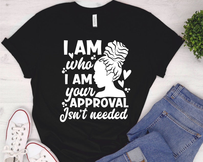 May include: Black t-shirt with a white graphic of a woman with an afro bun and the text "I AM who I AM your APPROVAL Isn't needed".