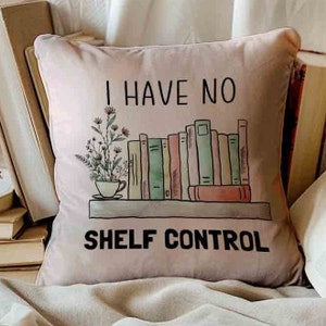 May include: A beige throw pillow with the text "I have no shelf control" and a graphic of a bookshelf with books and a potted plant.