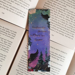 May include: Purple and blue bookmark with a black bird silhouette and a forest scene. The bookmark has the text "You could do anything if only you dared."