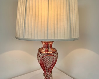 Vintage clear and red ruby cut glass side table lamp with cream shade mounted on a mahogany round base
