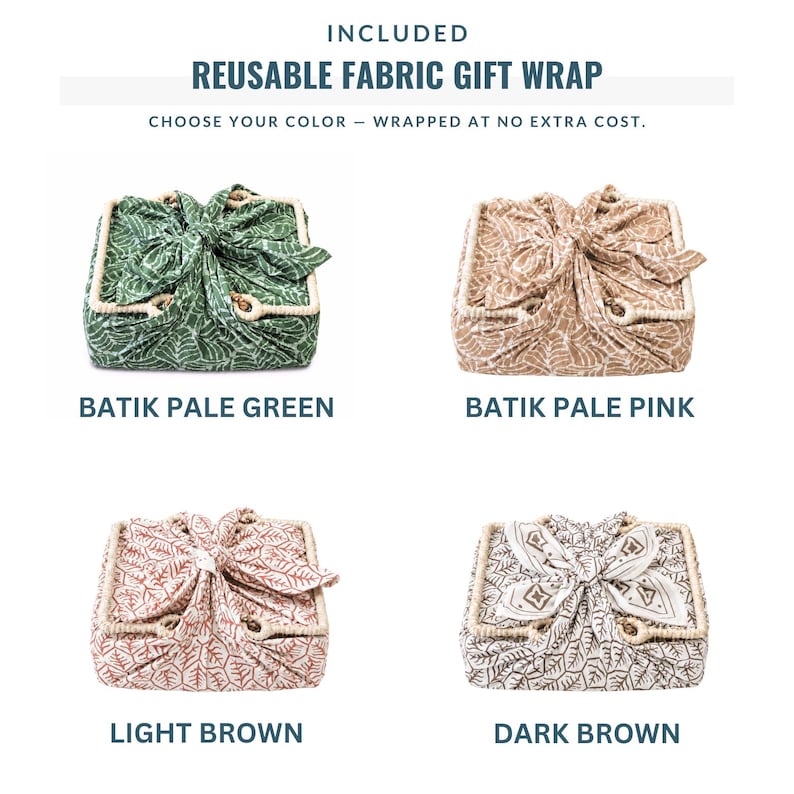 May include: Four square gift boxes wrapped in reusable fabric with knotted tops. The fabric patterns include batik pale green, batik pale pink, light brown, and dark brown leaf designs. Each box features a light-colored woven trim along the edges.