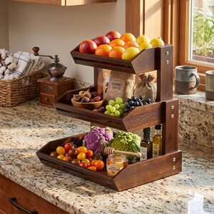 May include: A three-tiered, dark wood fruit and vegetable stand filled with fresh produce. The top tier holds apples, oranges, and lemons. The middle tier has figs, grapes, and a bag of coffee. The bottom tier displays tomatoes, cauliflower, and honey.