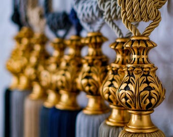 May include: A set of five gold tassel tiebacks with intricate floral designs. The tassels are made of a soft, luxurious fabric and are available in a variety of colors.