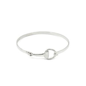 May include: A silver bangle bracelet with a snaffle bit design.