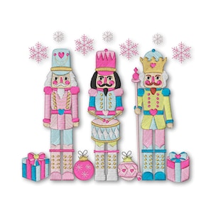 May include: Three pink, blue, and yellow toy nutcracker soldiers with gold accents stand in a row. The soldier on the left is holding a gift box, the middle soldier is playing a drum, and the soldier on the right is holding a staff. There are pink and white snowflakes in the background.