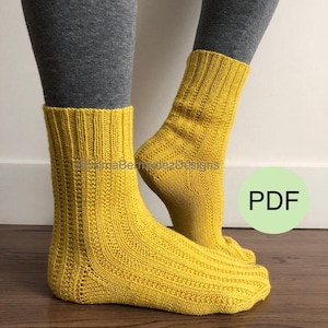 May include: A pair of yellow knitted socks with a ribbed pattern. The socks are ankle-high and are shown on a person's legs. The image includes the word "PDF" in a green circle.