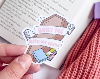 May include: A pink and brown sticker with a coffin and books. The sticker says "BURY ME WITH MY BOOKS".