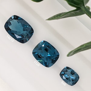 May include: Three blue topaz gemstones of different sizes. The largest measures 14x10 mm, the middle measures 11x9 mm, and the smallest measures 8x6 mm.