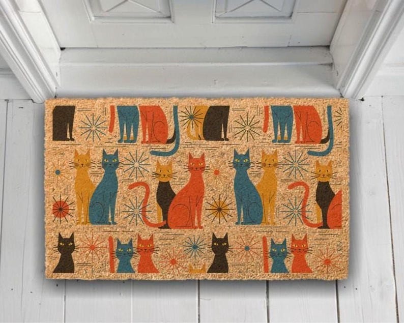 A colorful, patterned door mat with various cat illustrations on it.