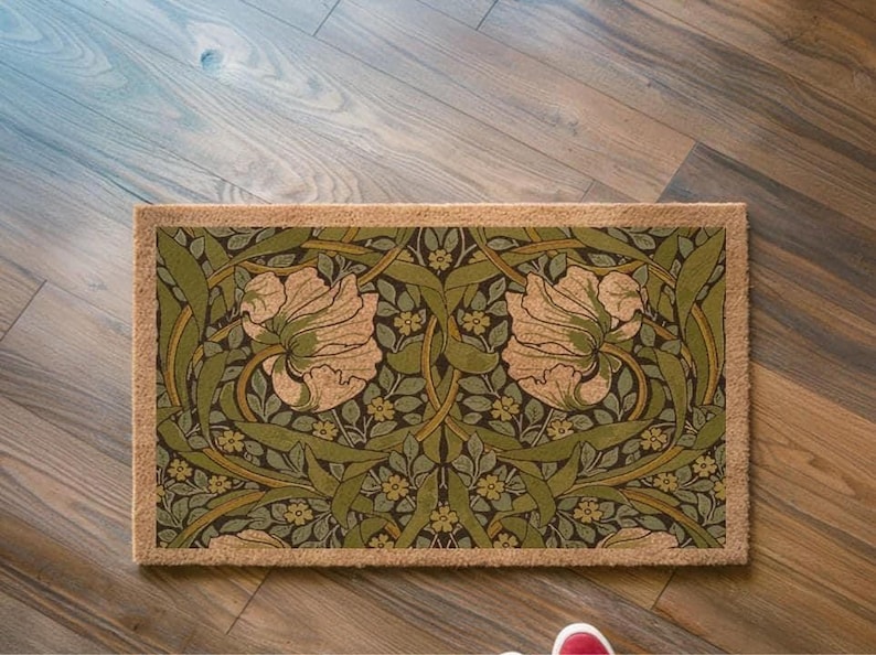 A decorative area rug with a floral pattern on a wooden floor.