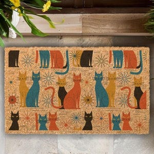 A colorful, patterned door mat featuring various cat illustrations in different colors and poses.