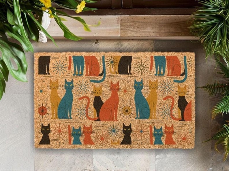 A colorful, patterned door mat featuring various cat illustrations in different colors and poses.