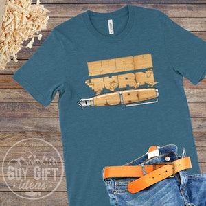 May include: A teal blue t-shirt with the words "Turn Turn Turn" written in wood-like letters. A wooden pen is below the words.