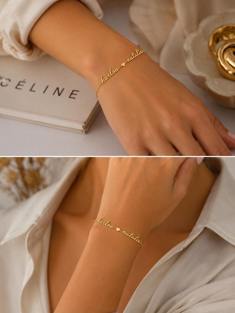 K&ouml;nnte beinhalten: Ein goldfarbenes Kettenarmband mit zwei in Schreibschrift verfassten Namen, "harlow" und "natalie", die durch einen kleinen herzf&ouml;rmigen Anh&auml;nger getrennt sind. Die feine Metallkette verbindet die Namen zu einem durchgehenden, personalisierten Schmuckst&uuml;ck.