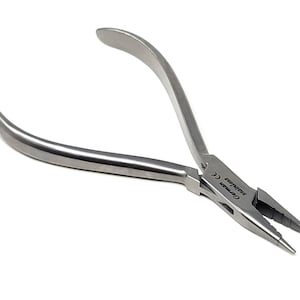May include: Silver-toned pliers with a curved handle and a pointed tip. The pliers are labeled "German Stainless CE".
