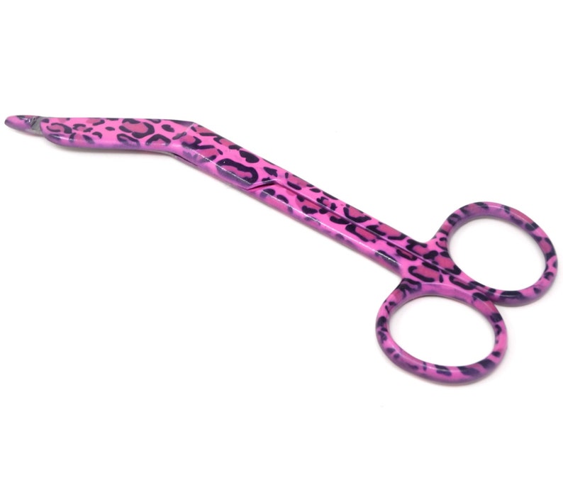 May include: Pink surgical scissors with a leopard print design.