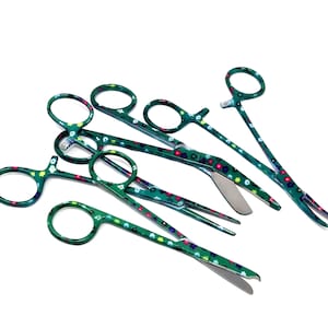 May include: A set of five green surgical scissors with floral patterns. The scissors have different lengths and styles, including straight and curved blades.