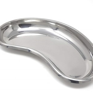 May include: A stainless steel kidney dish, a medical tray with a curved shape, used for holding medical instruments or supplies.