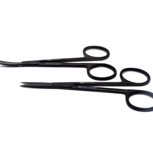 May include: Three black surgical scissors with curved blades. The scissors are made of stainless steel and have a black finish. The scissors are labelled "Stainless Steel CE".