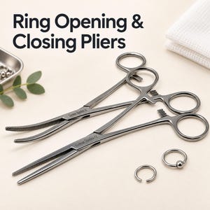 May include: Two silver-toned stainless steel ring opening and closing pliers with finger loops and serrated tips, each engraved with the text German Stainless CE. Two small circular metal rings are positioned near the pliers.