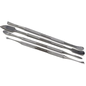 May include: Set of four stainless steel tools with different shaped tips. The tools have a textured handle and are labeled "German Stainless".