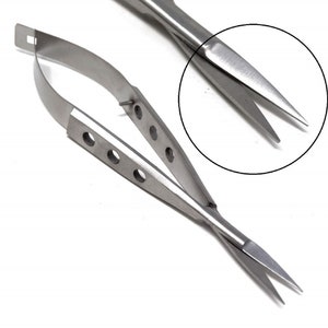 May include: A pair of stainless steel surgical scissors with a curved handle and a pointed tip. The scissors have a ring handle and a locking mechanism.