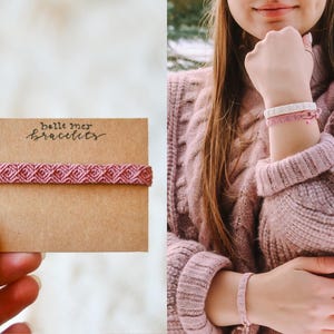 Puede incluir: Primer plano de una pulsera rosa tejida sobre una tarjeta marr&oacute;n con el texto "belle mer bracelets". La imagen tambi&eacute;n muestra a una persona con un su&eacute;ter rosa y varias pulseras rosas. Las pulseras tienen un patr&oacute;n geom&eacute;trico.