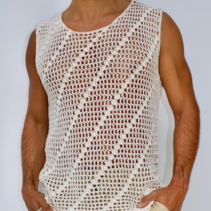 May include: A white crocheted sleeveless shirt with a diamond pattern. The shirt is worn over a pair of beige shorts.
