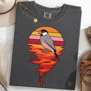 May include: A set of three ceramic mugs with a speckled, matte finish. The mugs are in shades of cream, light grey, and dark grey. Each mug has a simple, minimalist design, ideal for coffee or tea.